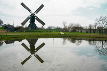 Polder mill Ter Leed in Leerdam, The Netherlands. With reflection in water. Space for text