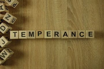 Temperance word from wooden blocks on desk - obrazy, fototapety, plakaty