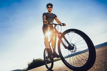 Man ride mountain bike on the road. Sport and active life concept.