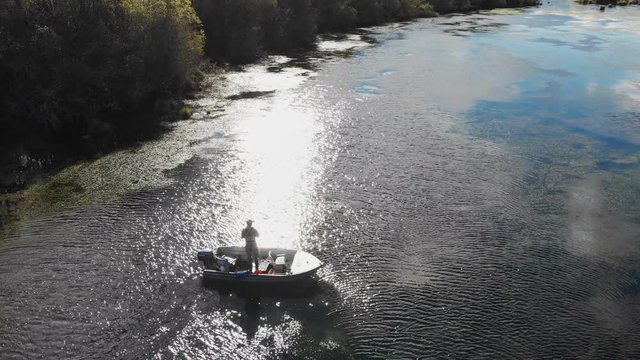 Aerial drone view of fisherman fly fishing from a drifting boat in New Zealand