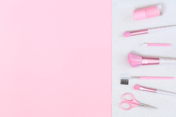 Feminine accessories and unicorn makeup brushes on silver pink background. Flat lay with copy space, beauty and cosmetics blogger concept