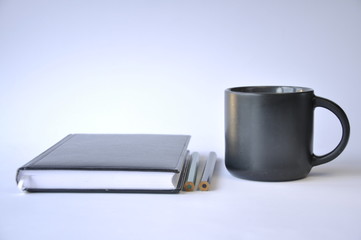cup of coffee and notebook on table