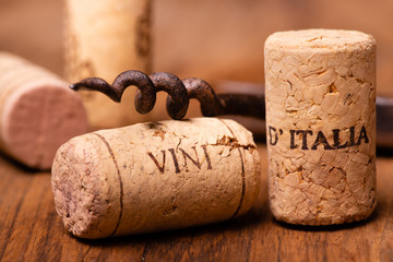 in the foreground, corks of Italian wine, and vintage corkscrews - 263748213
