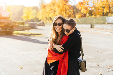 Fototapeta premium Portrait two beautiful happy girlfriends in the park.