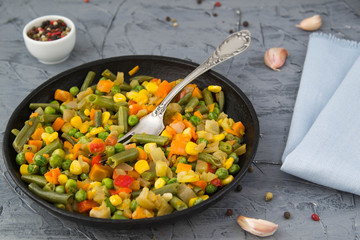 Cooked chopped vegetables in a boiling pan with spices. Vegan food.