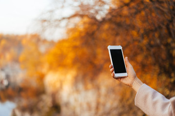 Female hand holding a phone, black screen