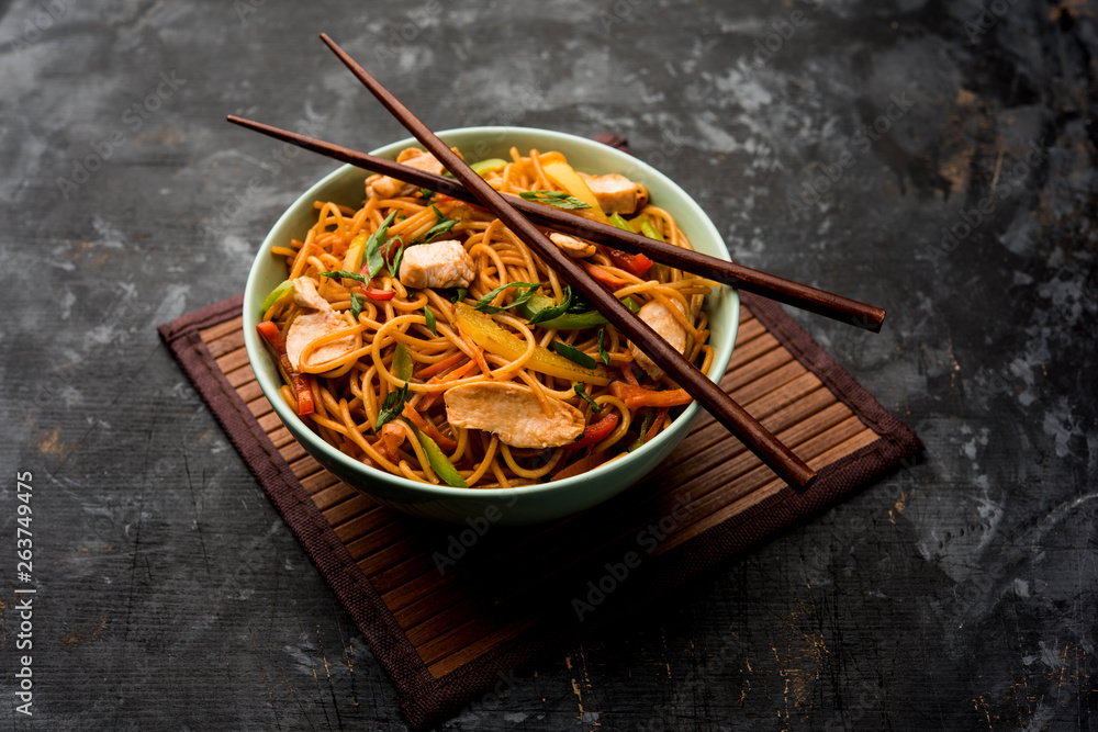 Canvas Prints Chicken Hakka/Schezwan noodles served in a bowl with chopsticks. selective focus