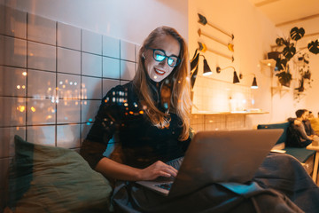 Woman works at a cafe in the evening
