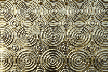 metal surface with embossed golden concentric circle layered pattern, elegance gold metallic wall for interior home decor oriental style, abstract texture background