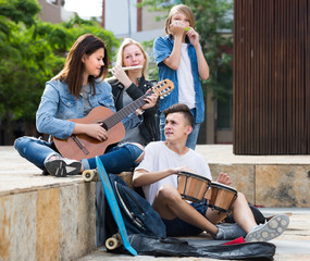 Cheerful teenagers with musical instruments