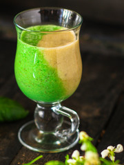 Smoothies, banana, basil, spinach, chia seeds and more are healthy food concepts. food background. top view