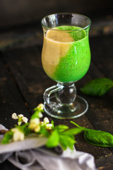 Smoothies, banana, basil, spinach, chia seeds and more are healthy food concepts. food background. top view