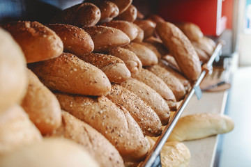 Close up of fresh baked roll on shelve ready to eat. Bakehouse interior.