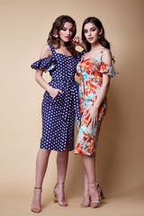 Two pretty beautiful sexy elegance woman skin tan body fashion model glamor pose wear trend dress...