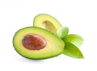 Ripe cut avocado with leaves isolated on white background. Healthy food