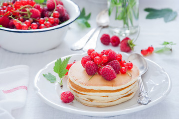 Homemade Pancakes with fresh red berries and honey