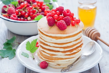 Homemade Pancakes with fresh red berries and honey