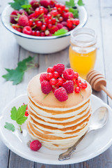 Homemade Pancakes with fresh red berries and honey