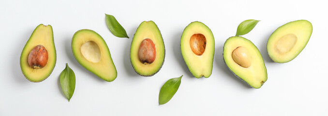 Flat lay composition with ripe avocados on white background, space for text
