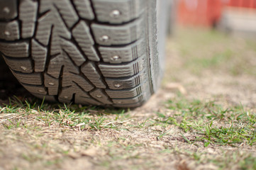 Obraz premium replacement of winter tires on the grass