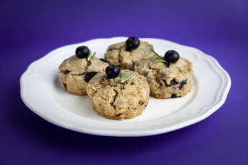 Fresh Baked Raspberry and Blueberry oatmeal wheat Scones set on Blue Background.