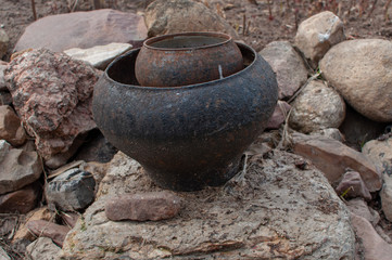 cast iron pot on stones