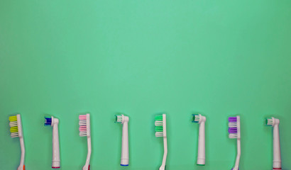 A lot of toothbrushes lie on aquamarine background. Top view, flat lay. Minimal concept