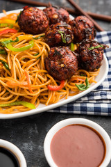 Manchurian Hakka / Schezwan noodles, popular indochinese food served in a bowl. selective focus