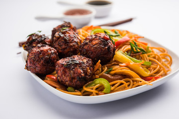 Manchurian Hakka / Schezwan noodles, popular indochinese food served in a bowl. selective focus