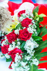 Valentines day background. Beautiful bouquet of roses on wooden table . Luxury bouquet made of red roses in flower shop Valentines Bouquet of red roses.  Rose bouquet. Soft focus of a Rose .