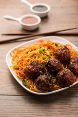 Manchurian Hakka / Schezwan noodles, popular indochinese food served in a bowl. selective focus