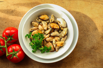 mussels A serving of seafood is a white plate. food background. top image