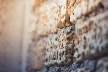 old wall of limestone with grey seams, perspective view
