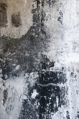 Grungy black and white painted cement wall