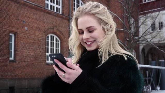 Enthusiastic young beautiful teen girl is using Tinder dating app swiping left and right trying to get a match.
