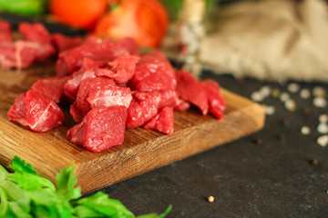 meat raw sliced, cut pieces on a cutting board, fresh. top view. food background