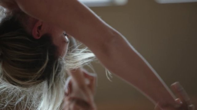 Partner Yoga aerial performance done by two professional instructors with hand-to-hand pose