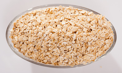Top view of oat flakes in glass bowl