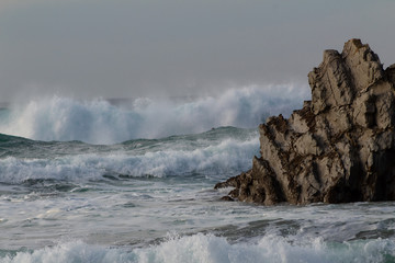 Fototapeta premium rock in the sea, which is hit by the waves. On the beach of Atxabiribil in Sopelana