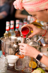 female bartender preparing cocktail in a cocktail bar