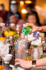 female bartender preparing cocktail in a cocktail bar
