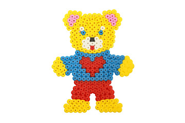 Handmade applique bear in an apron made of tubes isolated on white background