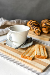 Continental breakfast - coffee, orange juice and toast on white wood table. Background with free text space.