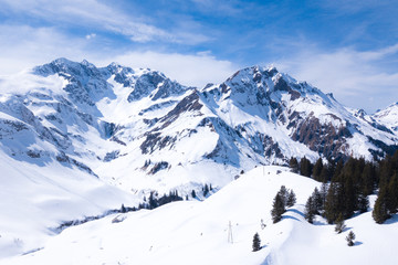 Fototapeta na wymiar winter landscape with blue sky in austria by drone