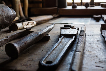 Old vintage blacksmith tools in the old smithy on the windowsill
