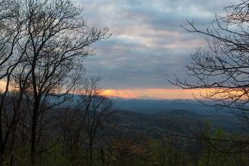 Fototapeta na wymiar Sunrise through the clouds over the Georgia Blue Ridge Mountains from Hike Inn in the Chattahoochee National Forest in early spring.
