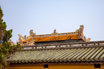 Fototapeta na wymiar Ornate rooftop in Citadel of Hue in Vietnam