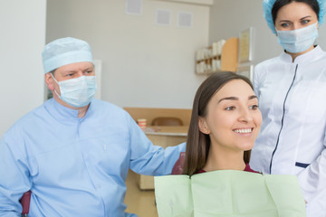 Young woman sits in a dental chair as a patient. People health care, dentistry, medicine concept. Doctor and patient. Teeth dentist with patient in hospital