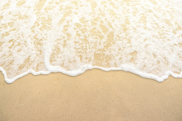 softly wave on the sand beach sunset