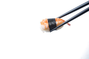 Sushi in chopsticks on isolated white background